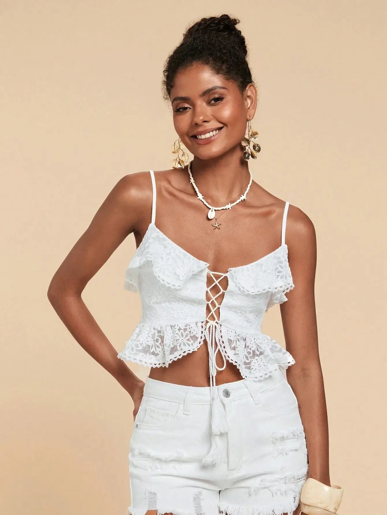 Woman wearing Seaside Lace-Up Ruffle Top with floral lace, ruffle trim, and lace-up front — perfect for beach vacations or summer outings