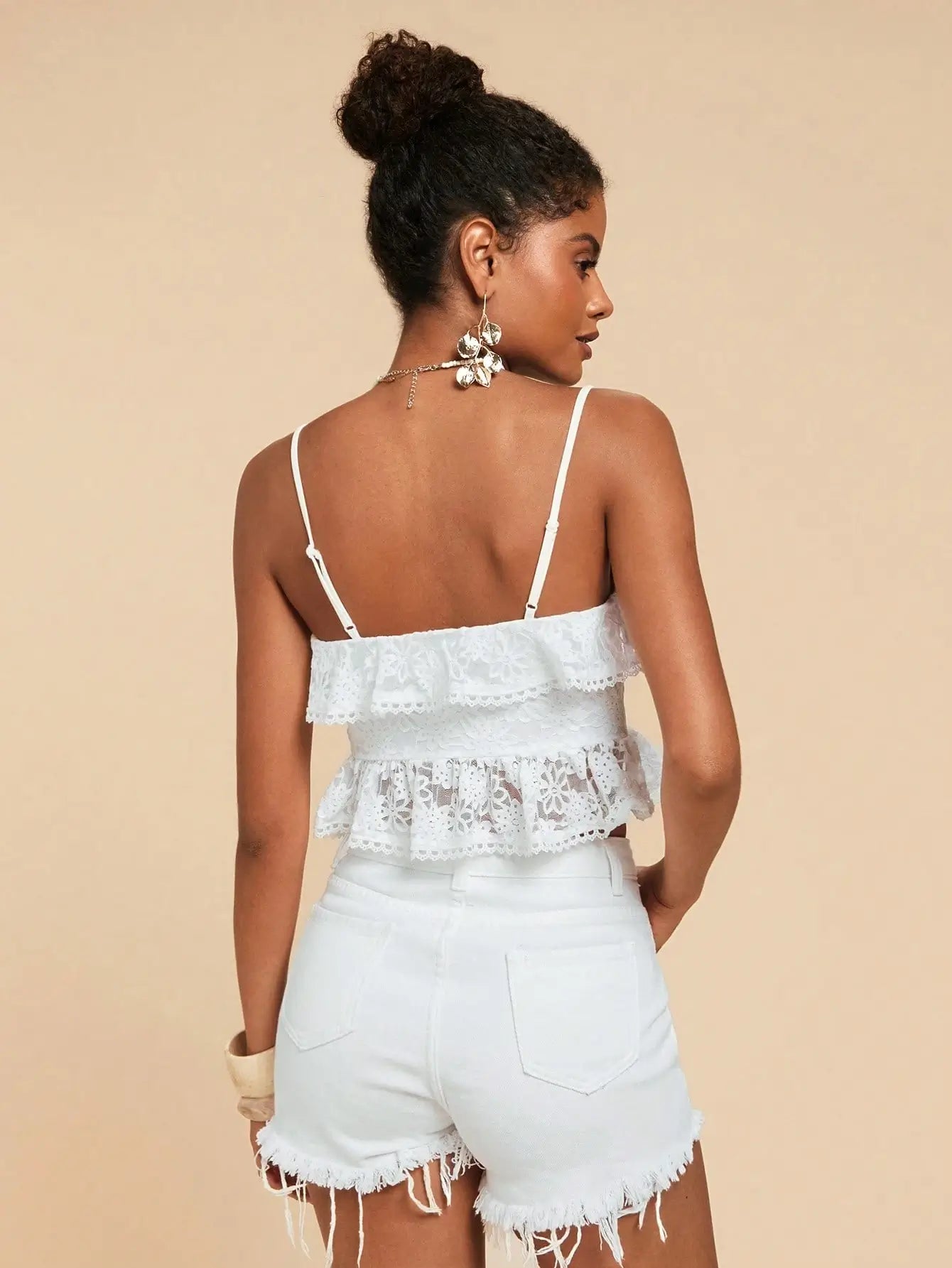 Woman wearing Seaside Lace-Up Ruffle Top with floral lace, ruffle trim, and lace-up front — perfect for beach vacations or summer outings