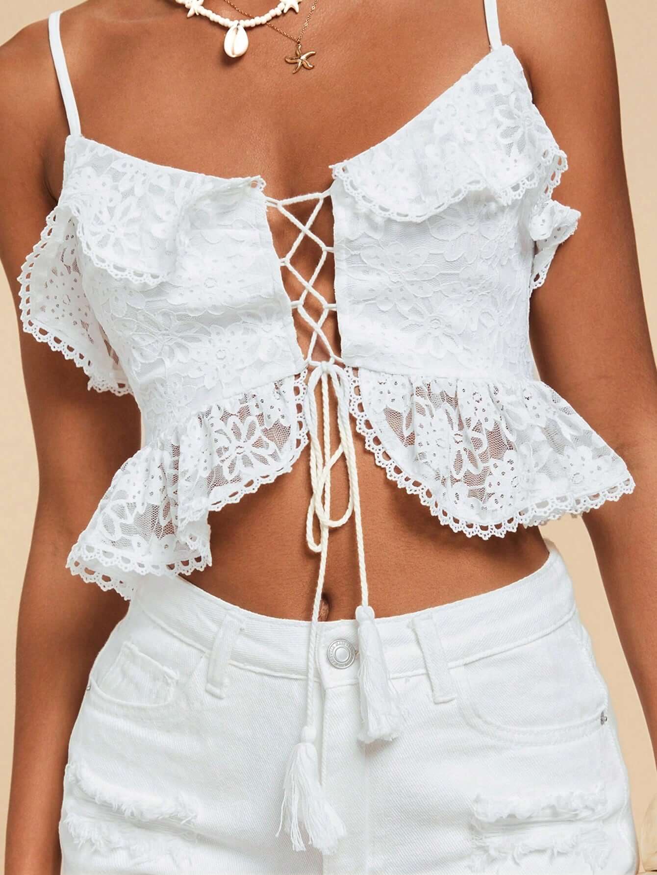 Woman wearing Seaside Lace-Up Ruffle Top with floral lace, ruffle trim, and lace-up front — perfect for beach vacations or summer outings